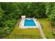 Aerial view of a private backyard swimming pool surrounded by lush greenery, perfect for summer relaxation at 2230 Mcbrayer Ct, Cumming, GA 30028
