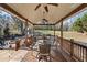 Inviting covered porch with dining, fire pit, and backyard access for relaxing and entertaining at 2230 Mcbrayer Ct, Cumming, GA 30028
