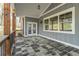 Covered back porch with stone tile flooring and wood pillars, perfect for outdoor living at 3068 Turning Creek Trail, Dacula, GA 30019