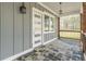 Charming back porch with slate flooring, wooden posts, and craftsman style door at 3068 Turning Creek Trail, Dacula, GA 30019