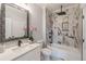 Modern bathroom with quartz countertop, patterned mirror, and tiled shower at 3068 Turning Creek Trail, Dacula, GA 30019