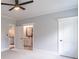 Bedroom featuring ceiling fan and open access to a bathroom and hallway at 3068 Turning Creek Trail, Dacula, GA 30019