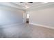 Bright bedroom with neutral paint, carpet, and view of hallway and living room at 3068 Turning Creek Trail, Dacula, GA 30019