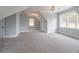 Bright bonus room with soft carpet, white trim and natural light from large windows at 3068 Turning Creek Trail, Dacula, GA 30019
