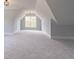 Spacious bonus room featuring neutral carpet, dormer window, and vaulted ceiling at 3068 Turning Creek Trail, Dacula, GA 30019
