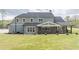 Back exterior view featuring a covered porch and well-manicured lawn at 3068 Turning Creek Trail, Dacula, GA 30019