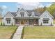 Charming two-story home featuring a welcoming front porch and beautifully landscaped front yard at 3068 Turning Creek Trail, Dacula, GA 30019