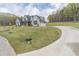 Expansive front yard with a winding driveway leading to a well-maintained, two-story home at 3068 Turning Creek Trail, Dacula, GA 30019