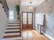 Elegant foyer featuring a staircase, chandelier, hardwood floors and a textured accent wall at 3068 Turning Creek Trail, Dacula, GA 30019
