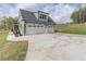 Spacious three-car garage with ample parking space and a well-manicured lawn at 3068 Turning Creek Trail, Dacula, GA 30019