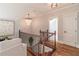 Hallway with wood floors, chandelier, art, and wood staircase leading to downstairs at 3068 Turning Creek Trail, Dacula, GA 30019