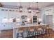 Modern kitchen featuring white cabinets, quartz countertops, stainless steel appliances and a large center island with seating at 3068 Turning Creek Trail, Dacula, GA 30019