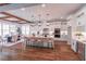 Spacious kitchen featuring white cabinets, stainless steel appliances, a large island, and a dining area with natural light at 3068 Turning Creek Trail, Dacula, GA 30019