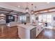 Open kitchen and living space features a large kitchen island and seamless views into the comfortable living room area at 3068 Turning Creek Trail, Dacula, GA 30019
