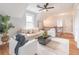 Bright living room with neutral furniture, ceiling fan, and hardwood floors at 3068 Turning Creek Trail, Dacula, GA 30019