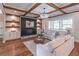 Cozy living room featuring built-in shelving, a fireplace, and an abundance of natural light at 3068 Turning Creek Trail, Dacula, GA 30019