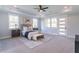 Spacious main bedroom with tray ceiling, recessed lights, carpet floor, and abundant natural light at 3068 Turning Creek Trail, Dacula, GA 30019