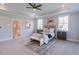 Large main bedroom boasts a tray ceiling, carpet floors, and dual windows for ample natural light at 3068 Turning Creek Trail, Dacula, GA 30019