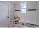 Well-organized mudroom featuring coat hooks, a bench with storage, and a window for natural light at 3068 Turning Creek Trail, Dacula, GA 30019