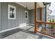 Covered porch featuring wood columns, dark metal railings and an outdoor seating area at 3068 Turning Creek Trail, Dacula, GA 30019