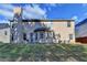 Backyard featuring a two-story home with a patio and a fenced yard at 4463 Grove Lake St, Loganville, GA 30052
