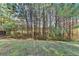 Expansive backyard featuring a wooded lot, adding privacy and a natural setting to the property at 4463 Grove Lake St, Loganville, GA 30052