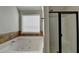 Bathroom featuring a modern tub and a glass shower with neutral paint and tile accents at 4463 Grove Lake St, Loganville, GA 30052