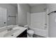 Bathroom with a sink and a toilet and bathtub with neutral paint and grey flooring at 4463 Grove Lake St, Loganville, GA 30052