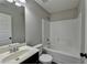 Bathroom with a sink and a toilet and bathtub with neutral paint and grey flooring at 4463 Grove Lake St, Loganville, GA 30052