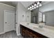 Bathroom featuring double sink vanity, large mirror with vanity lighting, and neutral paint at 4463 Grove Lake St, Loganville, GA 30052