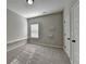 Neutral bedroom with shelving, carpet, window, and multiple doors at 4463 Grove Lake St, Loganville, GA 30052