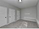 A neutral bedroom with three doors and two shelves at 4463 Grove Lake St, Loganville, GA 30052