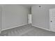 An airy bedroom with plush gray carpeting and a bright, neutral color scheme throughout at 4463 Grove Lake St, Loganville, GA 30052
