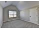 Cozy bedroom with neutral walls, carpeted floors, vaulted ceiling and window with blinds allowing natural light to fill the room at 4463 Grove Lake St, Loganville, GA 30052
