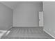 Bright bedroom showcasing plush gray carpeting and modern architectural details at 4463 Grove Lake St, Loganville, GA 30052
