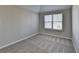 Cozy bedroom with neutral-colored walls, carpeted flooring and a window with blinds allowing natural light to fill the room at 4463 Grove Lake St, Loganville, GA 30052
