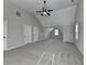 Light-filled bonus room featuring plush gray carpeting, vaulted ceilings and multiple windows at 4463 Grove Lake St, Loganville, GA 30052