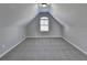 Cozy bonus room with plush carpeting, peaked ceiling and bright light from window at 4463 Grove Lake St, Loganville, GA 30052