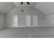 Expansive bonus room with plush gray carpet, vaulted ceilings and abundant natural light at 4463 Grove Lake St, Loganville, GA 30052