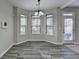 This dining area features lots of windows, neutral paint, and wood flooring at 4463 Grove Lake St, Loganville, GA 30052