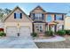 Charming two-story home with a well-manicured lawn, two-car garage, and inviting curb appeal at 4463 Grove Lake St, Loganville, GA 30052