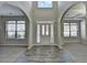 Bright open foyer showcasing the two-story ceiling, arched doorways, and stylish wood flooring at 4463 Grove Lake St, Loganville, GA 30052