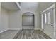 Elegant foyer featuring a two-story ceiling, arched entryway, wood floors and neutral paint at 4463 Grove Lake St, Loganville, GA 30052