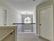 Open hallway featuring neutral walls, carpet, iron railing and a chandelier, offering a bright and airy transition between spaces at 4463 Grove Lake St, Loganville, GA 30052