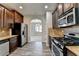Kitchen features stainless appliances, granite counters, tile backsplash, and wood flooring at 4463 Grove Lake St, Loganville, GA 30052