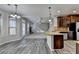 Open concept kitchen with center island, wood cabinets, granite counters, and stainless appliances at 4463 Grove Lake St, Loganville, GA 30052