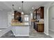 Kitchen features center island with sink, granite counters, dark cabinets, and stainless appliances at 4463 Grove Lake St, Loganville, GA 30052