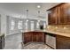 Open concept kitchen with granite counters, stainless appliances, wood cabinets, and kitchen island at 4463 Grove Lake St, Loganville, GA 30052