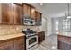 A modern kitchen with stainless steel appliances and granite countertops at 4463 Grove Lake St, Loganville, GA 30052