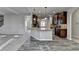 Kitchen with stainless appliances, granite counters, and wood-look floors at 4463 Grove Lake St, Loganville, GA 30052